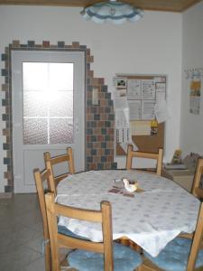 a dining room table and chairs with a bird on the table at Apartment Karin in Lutzmannsburg