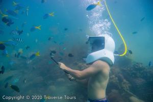 a woman with a head on a hose in the water at Mari Mari Sepanggar Lodge in Kota Kinabalu