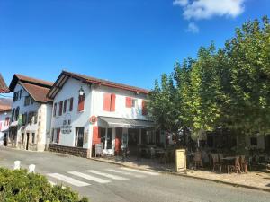 a street with a white building on the side of the road at Gîte chez Maritxu in Saint-Étienne-de-Baïgorry