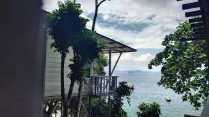 a balcony of a house with a view of the water at Mari Mari Sepanggar Lodge in Kota Kinabalu