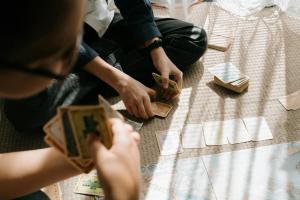 a group of people sitting on the floor playing cards at Studio 4 in Bad Schallerbach