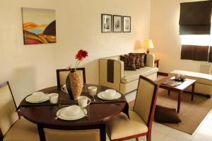 a living room with a table and a dining room at La Casarita in Manila