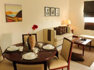 a living room with a dining table and a couch at La Casarita in Manila