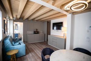 a living room with a blue couch and a table at CA' del SAL LUXURY APARTMENTS in Chioggia