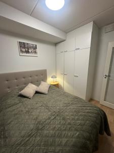 a bedroom with a large bed with two pillows at Lapland Apartments with sauna and free WiFi and parking in Rovaniemi