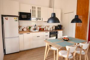 a kitchen with a table and a white refrigerator at Radawnica pl - Tu odpoczniesz! in Skorka