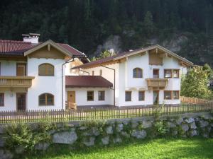 a large white house with a fence at Haus Peter Schiestl in Zell am Ziller