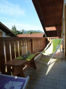 a picnic table and a hammock on a deck at Alpenpanorama vacation home in Bergen