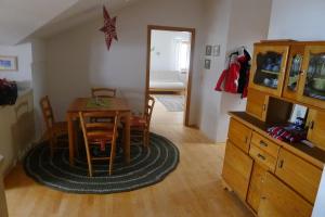a living room with a table and a dining room at Alpenpanorama vacation home in Bergen +4 photos
