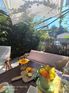 a table with a bowl of fruit on it at Apartma REA Izola, pergola & terassa, parking in Izola