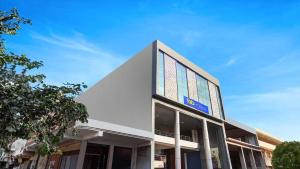 a building with a sign on the side of it at Golden Sky in Noida