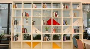 a large white book shelf filled with books at Borrman Hotel Xiamen Xiang'an Maxiang in Xiang'an