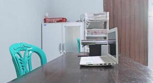 a laptop computer sitting on top of a wooden table at Hotel O Amor Kost in Oesapa-besar +44 photos