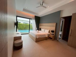 a bedroom with a bed and a large window at Sivana HideAway Villas Hua-Hin in Khao Tao +184 photos