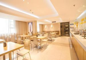 a restaurant with tables and chairs and a cafeteria at City Comfort Inn Nanning Jinhu Plaza Langxi Metro Station Exhibition in Nanning