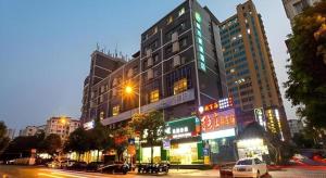 a tall building on a city street at night at City Comfort Inn Nanning Jinhu Plaza Langxi Metro Station Exhibition in Nanning