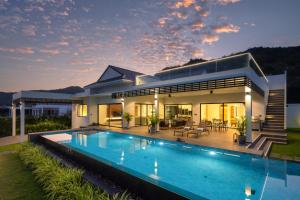 a house with a swimming pool in front of it at Sivana HideAway Villas Hua-Hin in Khao Tao