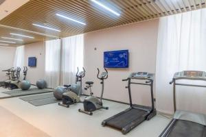 a gym with several exercise bikes and treadmills at Jinjiang Inn Tianshui Chunfeng Road Wanda Plaza in Tianshui