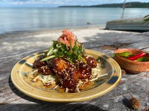 a plate of food on a table near the beach at Kerfuffle Bay in Koh Rong Island