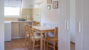 a kitchen with a wooden table and chairs at O.W.Cynamon in Dziwnów