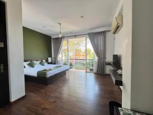 a bedroom with a bed and a sliding glass door at Lavinia Villa in Karagampitiya