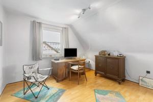 a room with a desk with a computer and a window at Ferienwohnung Ruhepol, 75qm in Vellmar