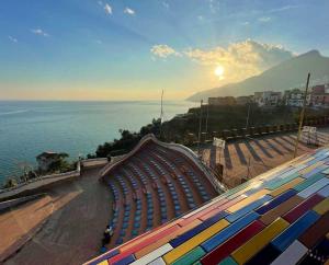 a view of a beach with the sun setting over the ocean at Il balcone sul corso in Vietri sul Mare