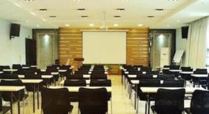 a lecture room with tables and chairs and a whiteboard at Jinjiang Inn select Hotel Kunming Economic Development Zone Kunming College in Kunming +79 photos
