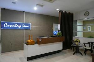 a lobby of a company with a sign on the wall at Country Inn in Kampong Saleng
