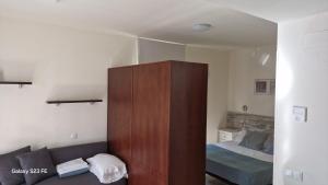 a bedroom with a couch and a bed in it at Apartamentos CARU in Castelldefels +32 photos