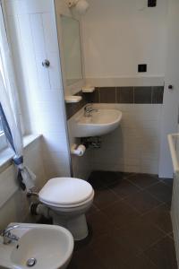a bathroom with a toilet and a sink at lecasedimarco2 in La Spezia +9 photos