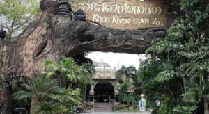 an entrance to a zoo with a sign in a tree at Sriracha Hotel And Spa in Ban Bang Phra