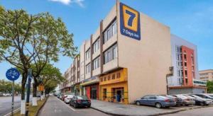 a large building with a parking lot in front of it at 7 Days Inn Foshan University Creative Industry Park in Shiwan