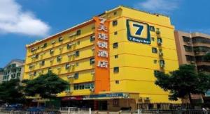 a yellow building with a sign on it at 7Days Inn Xuzhou Normal University Yunlong Mountain in Xuzhou