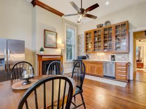 a kitchen with a table and chairs and a ceiling fan at Parlor on Lafayette in Savannah