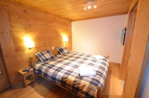 a bedroom with a bed in a wooden room at Adelaide A 03 in Grimentz