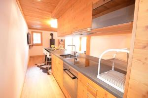 a kitchen with a sink and a counter top at Adelaide A 03 in Grimentz +4 photos