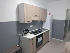 a kitchen with a stove and a refrigerator at B&B L'Amarti in Rogiano Gravina