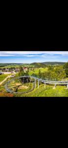 an aerial view of a park with a bridge at Un coin de paradis au pied des pistes avec balcon in Métabief +5 photos