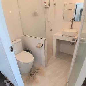 a small bathroom with a toilet and a sink at Baan Khun Nine in Ratchaburi +8 photos