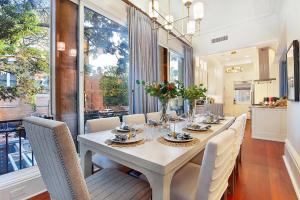 a dining room with a long table and chairs at 3 W Perry St in Savannah