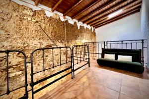 a room with a green couch on a wall at La Damajuana in Linares de la Sierra