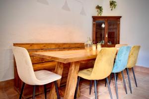 a wooden table with four chairs around it at La Damajuana in Linares de la Sierra +23 photos