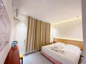 a hotel room with a bed and a window at Khamsay Hotel in Vientiane