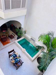 an overhead view of a swimming pool in a house at Riad Dar Amazonia in Marrakech +18 photos