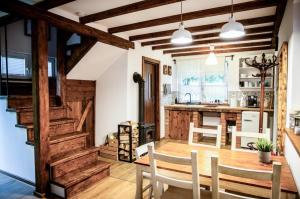 a kitchen with a table and chairs in a room at Domek pod Mogielicą in Chyżówki