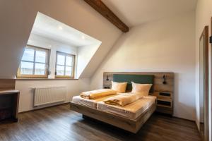 a bedroom with a large bed in a attic at Gutshof Colmberg in Colmberg