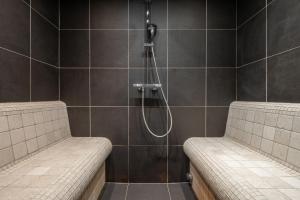a shower with two benches in a bathroom at Apartment Aelora Courchevel - by EMERALD STAY in Courchevel