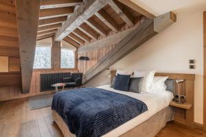 a bedroom with a large bed in a room with wooden ceilings at Apartment Aelora Courchevel - by EMERALD STAY in Courchevel