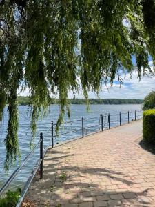 a brick walkway next to a body of water at Ferienwohnung Neuruppin in Neuruppin